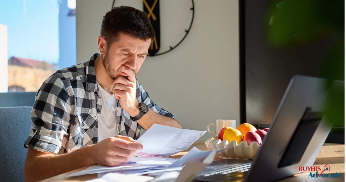 Man reviewing property documents at home to identify potential property scams before buying a home in Melbourne